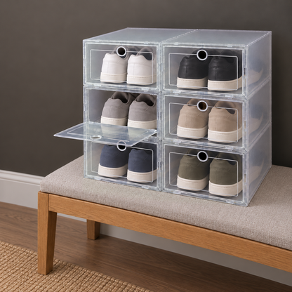 Six clear shoe boxes stacked on an upholstered bench, the middle-left box's front dropped down level while the others stay closed, a pair of sneakers in each