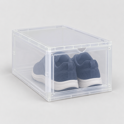 Translucent drop front shoe box with navy running shoes inside, on a plain light grey background