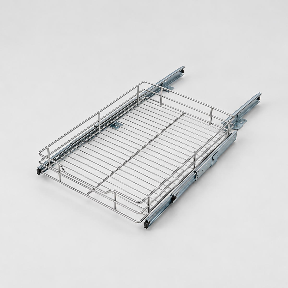 Small chrome wire pull-out cabinet organizer on two zinc drawer slides, three-quarter view on a light grey background
