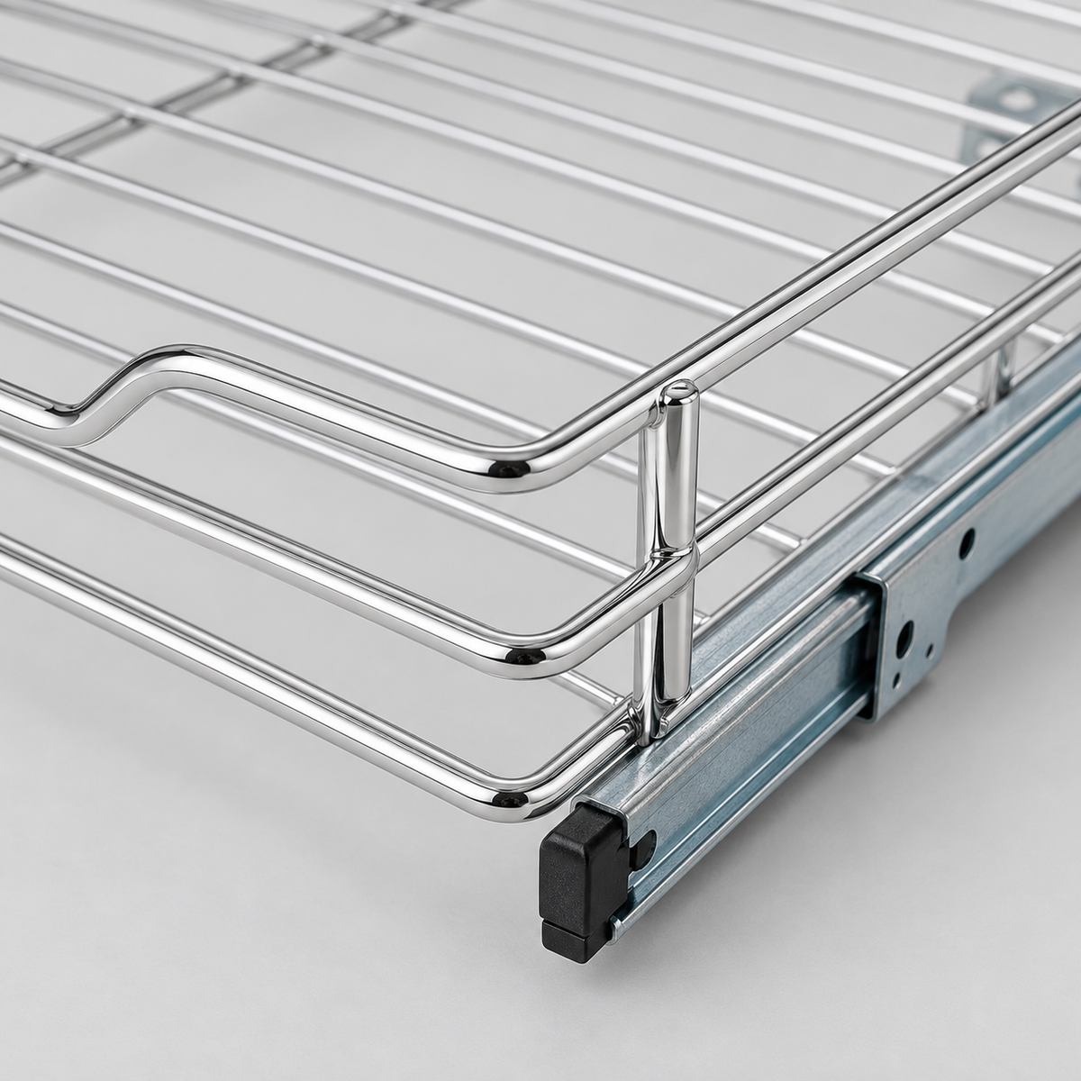 Close-up of the chrome front corner and finger notch above the zinc drawer slide with its black front stop