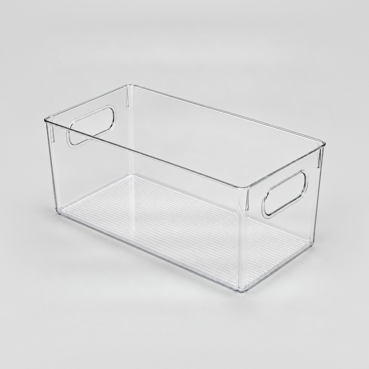 One empty clear open-top storage bin with a handle cut-out in each short end, on a light grey background