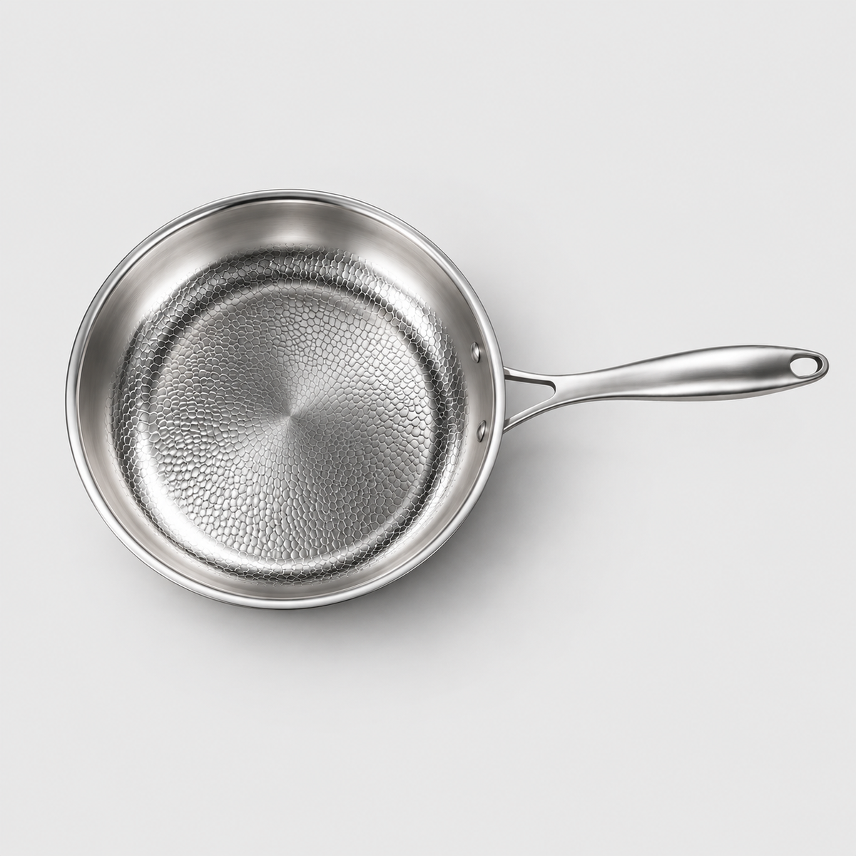 Top-down view of the hammered frying pan showing the full honeycomb interior and handle