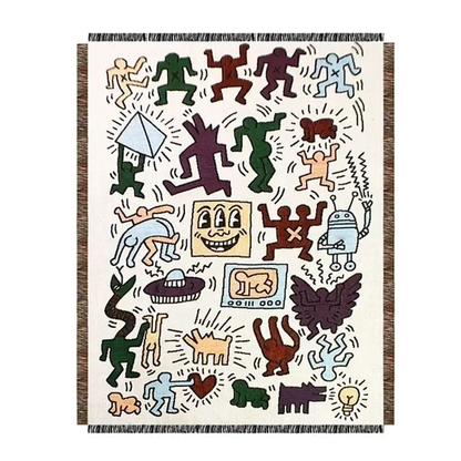 The doodle figure throw blanket laid flat on a white background, showing the full design and its fringed ends.