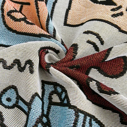 A close view of the jacquard weave twisted into a swirl, showing the colored yarns in peach, blue and deep red.