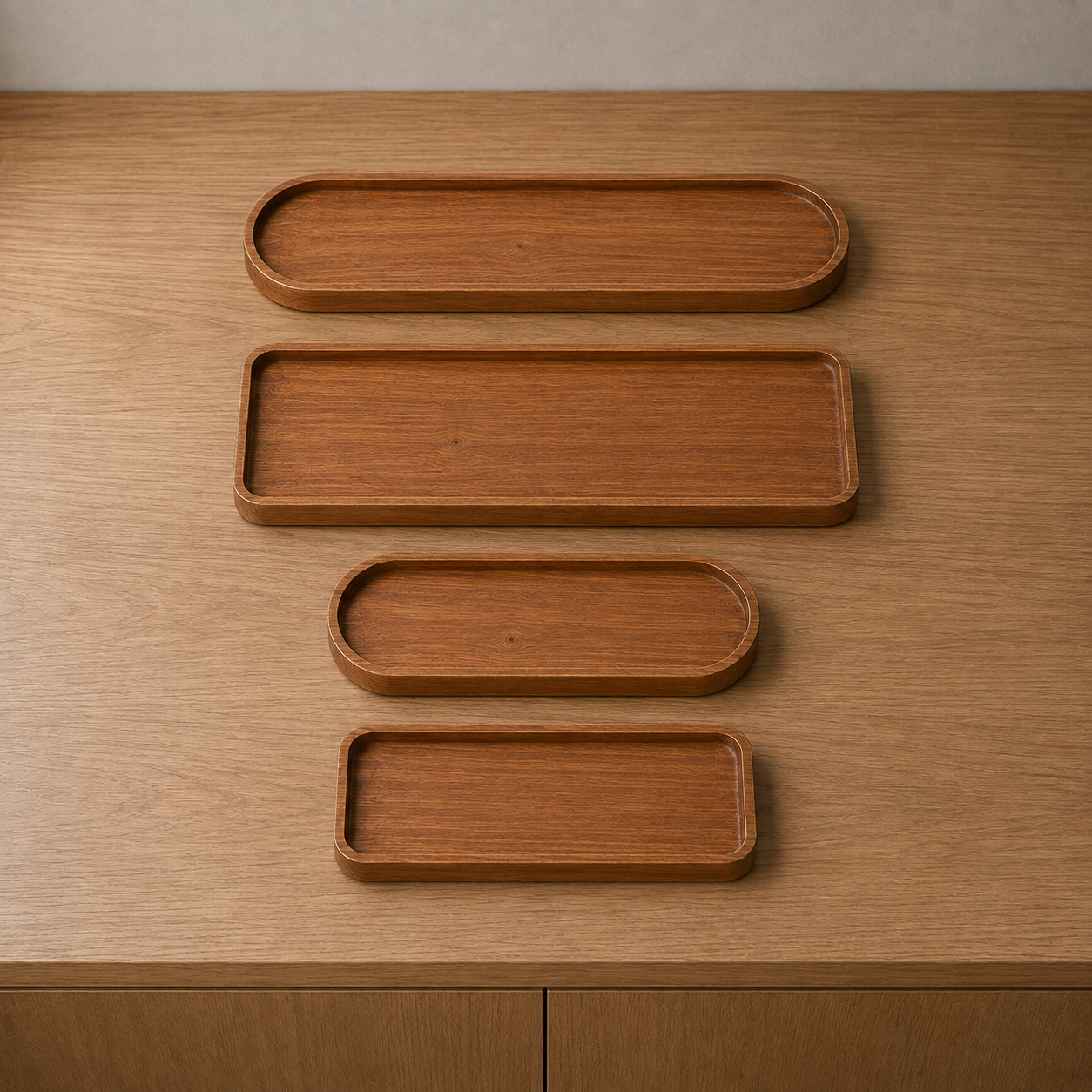 All four wooden trays together on a sideboard, two oval and two rectangular in two lengths