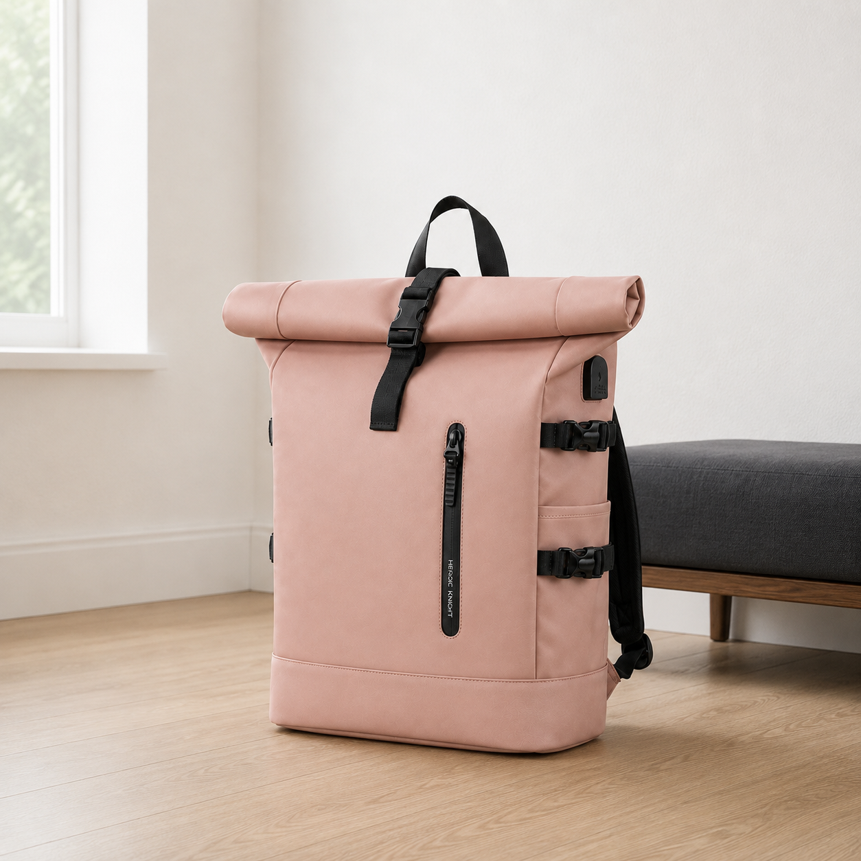 Pink roll top backpack in a white bedroom corner beside an oak and charcoal bench