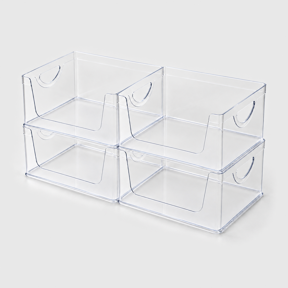 Set of four empty clear open-front pantry bins stacked two by two on a light grey background