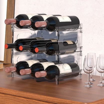 A clear three-tier rack holding nine bottles of red wine lying flat on a walnut sideboard beside wine glasses.