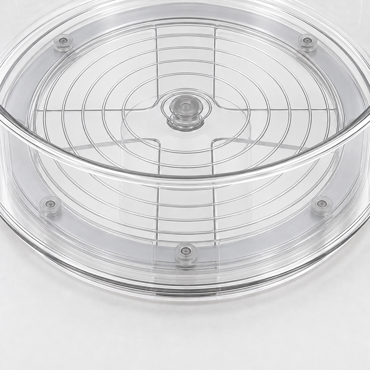 A close view through the clear floor of the turntable, showing the floor rings and the grey turning base with its studs.