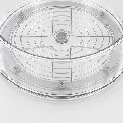 A close view through the clear floor of the turntable, showing the floor rings and the grey turning base with its studs.