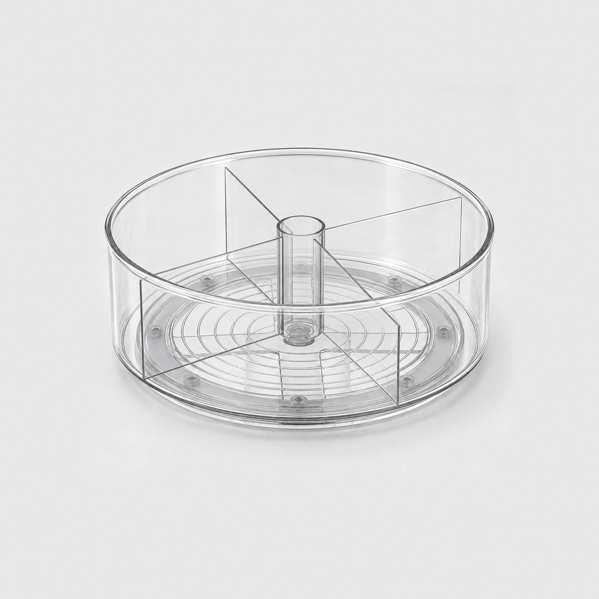 A clear round lazy Susan with four divider panels around a hollow center post, empty, on a light grey background.