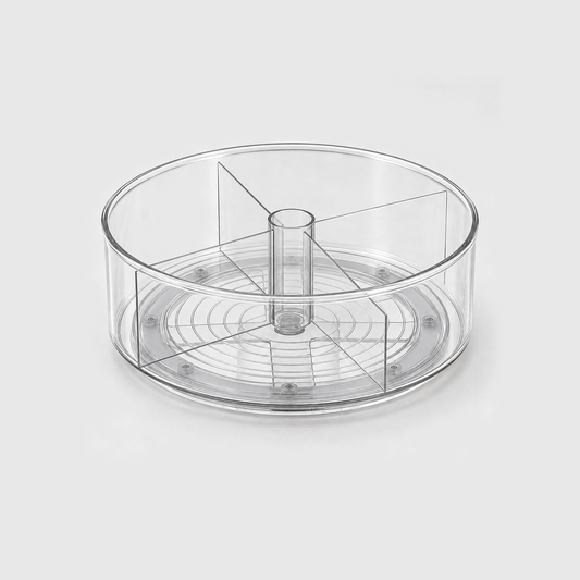 A clear round lazy Susan with four divider panels around a hollow center post, empty, on a light grey background.