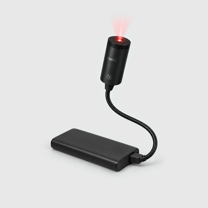 Christmas projector light switched on, its lens glowing red, the gooseneck plugged into a power bank (not included) on a gray background
