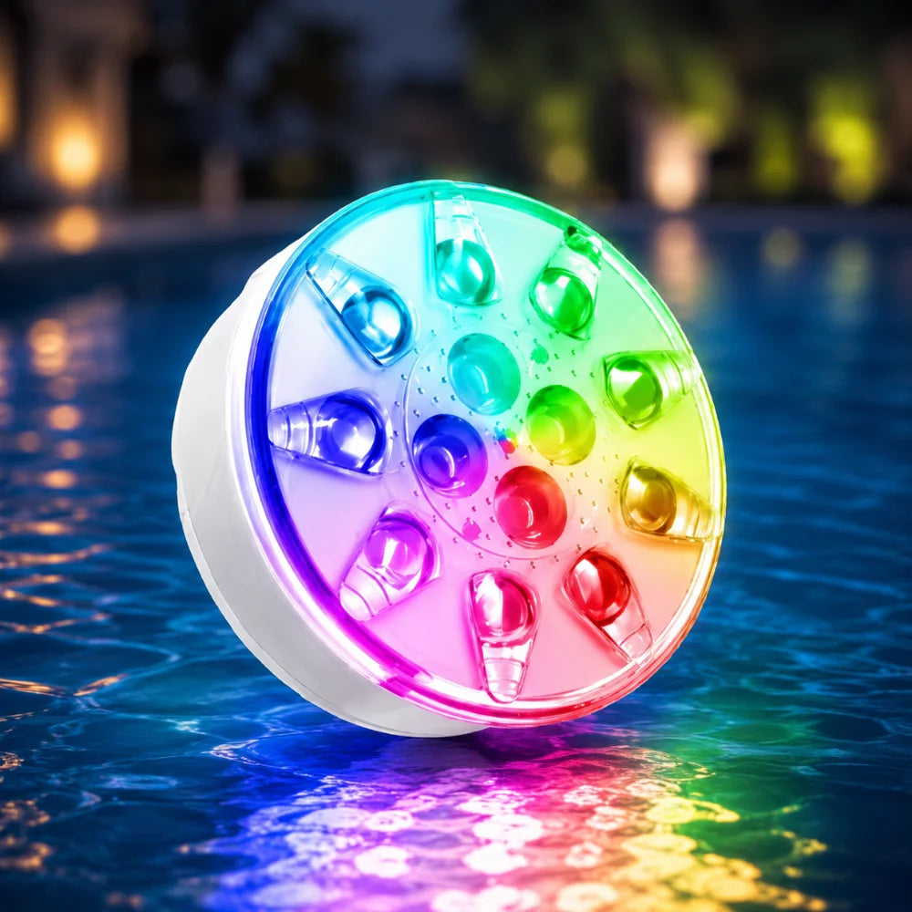 Lit pool light resting on the wet edge of a swimming pool at night, with its glow reflected in the water