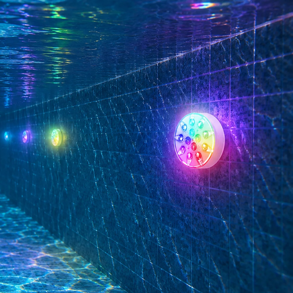 Pool lights shining along the wall of a swimming pool, seen from under the water