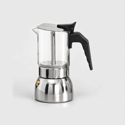 Glass moka pot with a clear borosilicate upper chamber, black handle and polished stainless steel base, on a light gray background