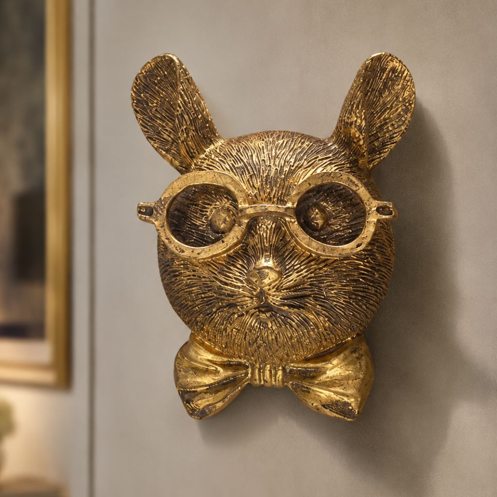 Mouse head wall sculpture with round glasses and a bow tie on a taupe wall