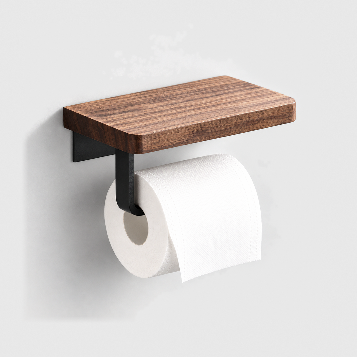 Walnut toilet paper holder with a matte black steel arm and a roll of toilet paper, mounted on a plain light gray wall