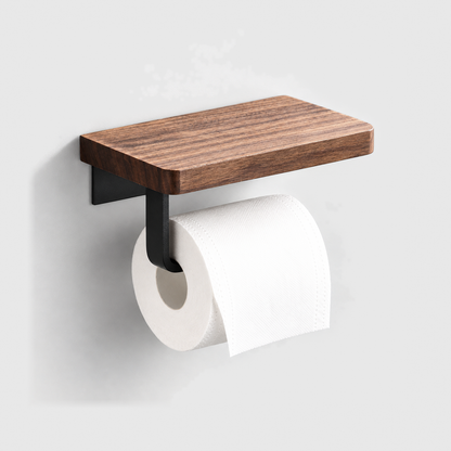 Walnut toilet paper holder with a matte black steel arm and a roll of toilet paper, mounted on a plain light gray wall