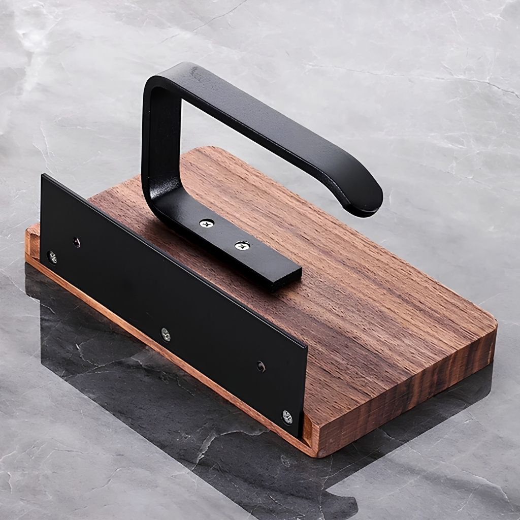 Underside of the walnut toilet paper holder, showing the black wall plate and the screwed-on steel arm
