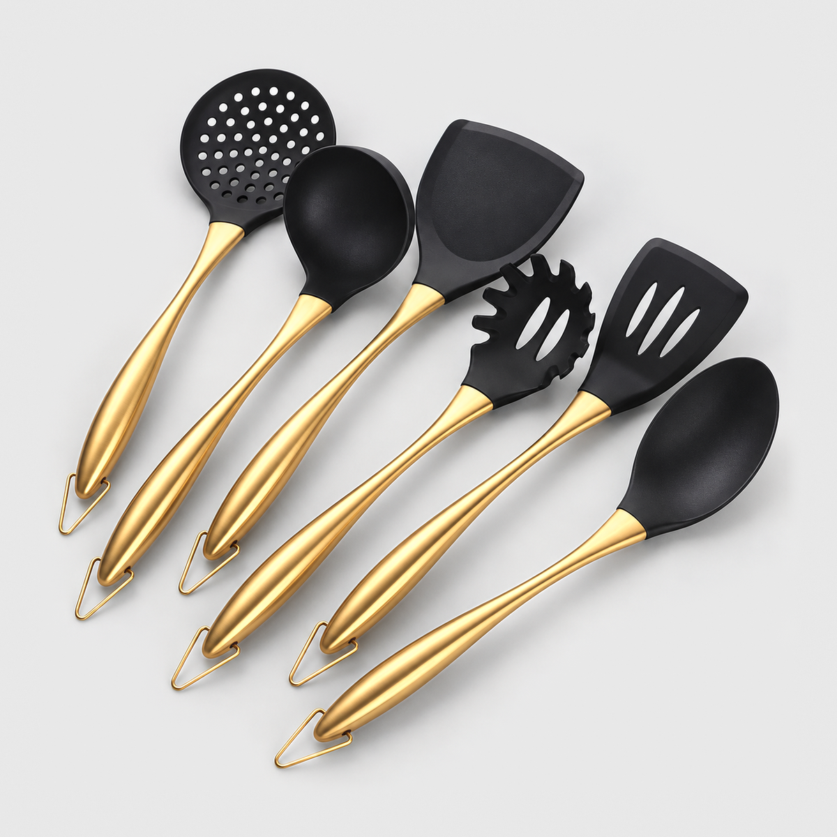 Six-piece cooking utensil set with black heads and gold-tone handles on a light gray background