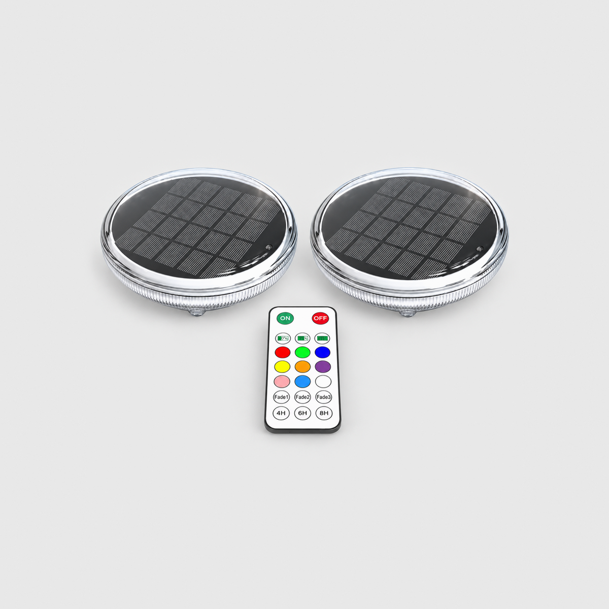 Two solar floating pool lights and one remote control on a light gray background