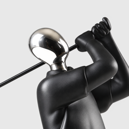 Close view of the mirror silver head and matte black shoulders of the golfer sculpture