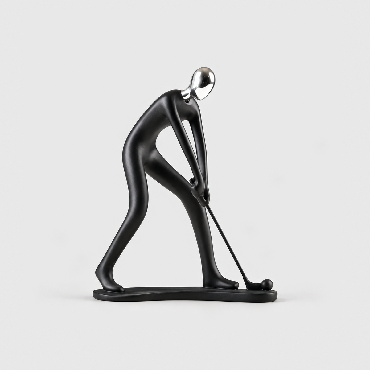 A matte black golfer sculpture bent over a putter with a ball on the base, on a light gray background