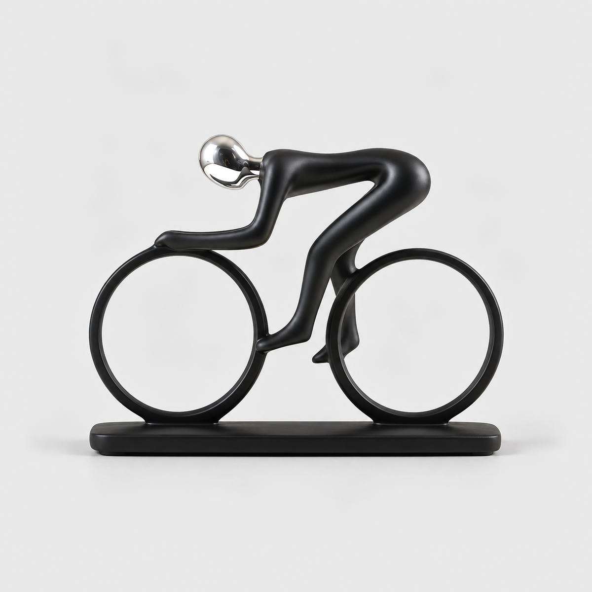 A matte black cyclist sculpture crouched over a bicycle made of two open rings, on a light gray background