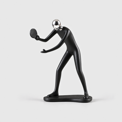 A matte black table tennis player sculpture leaning in with a round paddle, on a light gray background