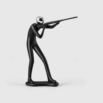 A matte black sport shooting sculpture aiming a long gun from the shoulder, on a light gray background