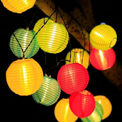 Close-up of multicolor lanterns in yellow, green and red glowing at night