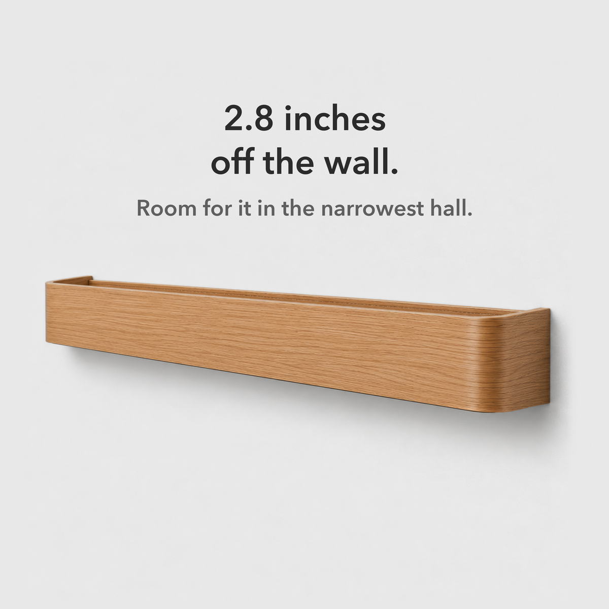 Natural wood wall shelf with hooks seen from the right, showing its slim 2.8 inch depth, card reading 2.8 inches off the wall