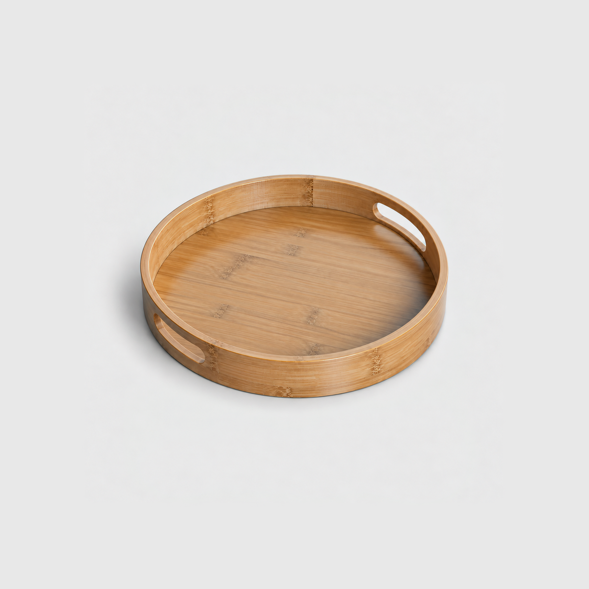 Medium round bamboo serving tray with two cut-out handles, on a light gray background