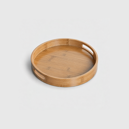 Medium round bamboo serving tray with two cut-out handles, on a light gray background