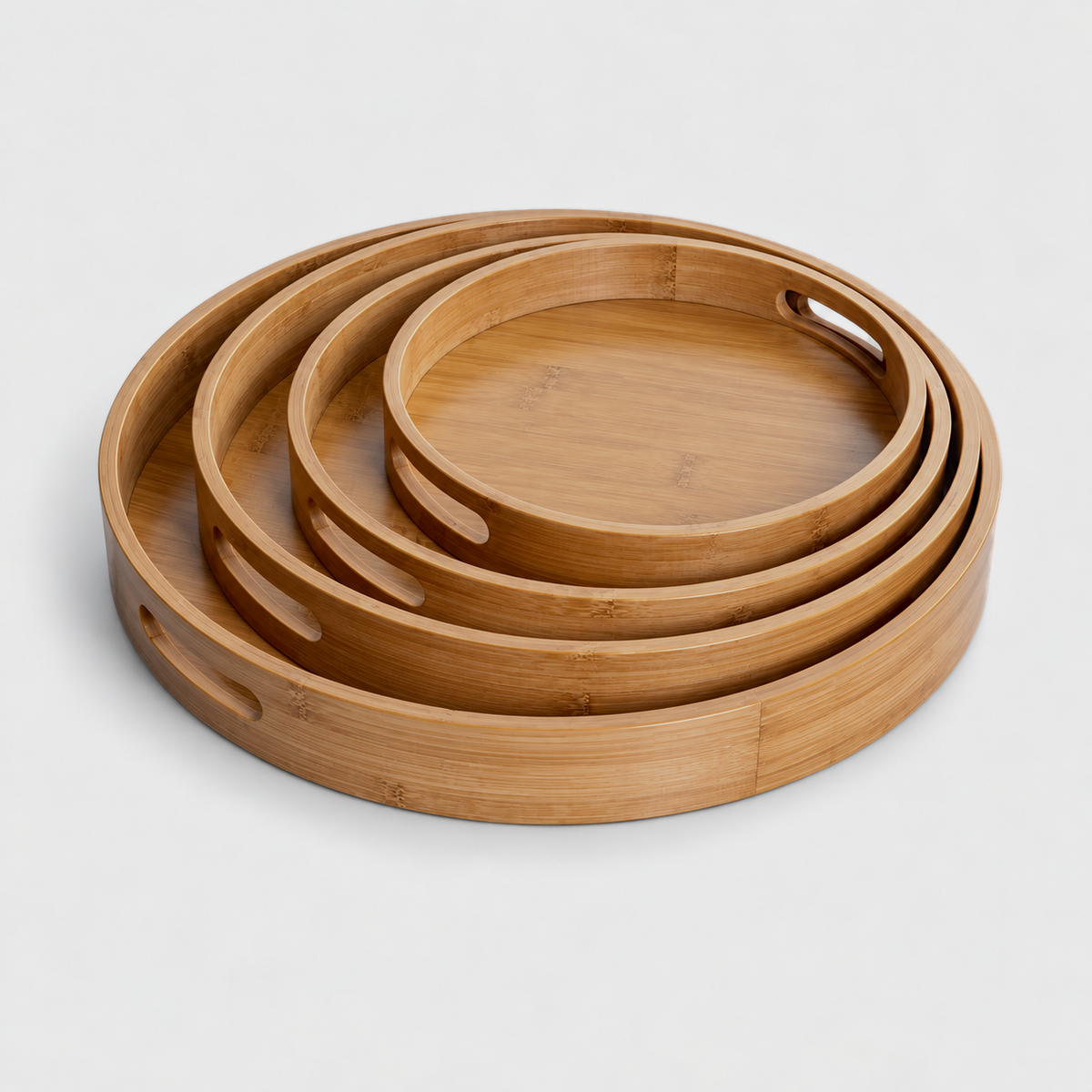 Round bamboo serving trays in all four sizes nested one inside another for compact storage; each size is sold separately