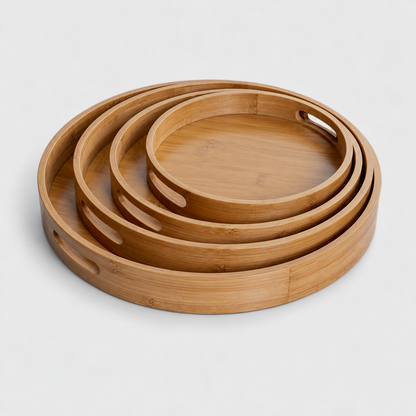 Round bamboo serving trays in all four sizes nested one inside another for compact storage; each size is sold separately