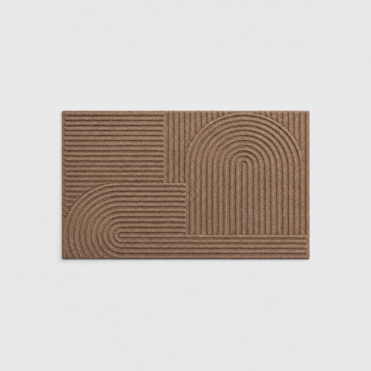 Brown grooved doormat with a raised arc pattern, seen from above on a light gray background