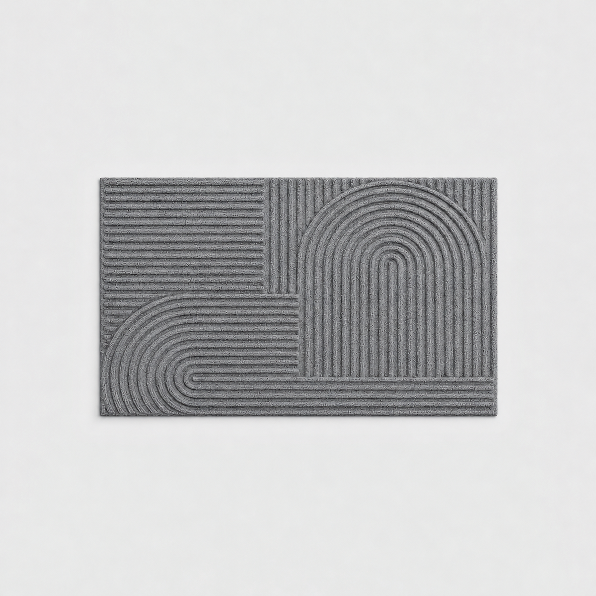Gray grooved doormat with a raised arc pattern, seen from above on a light gray background