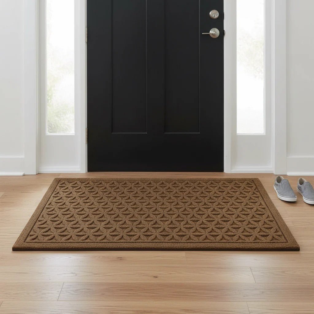 Brown grooved doormat with a raised lattice pattern inside a black front door