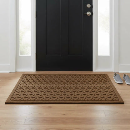 Brown grooved doormat with a raised lattice pattern inside a black front door