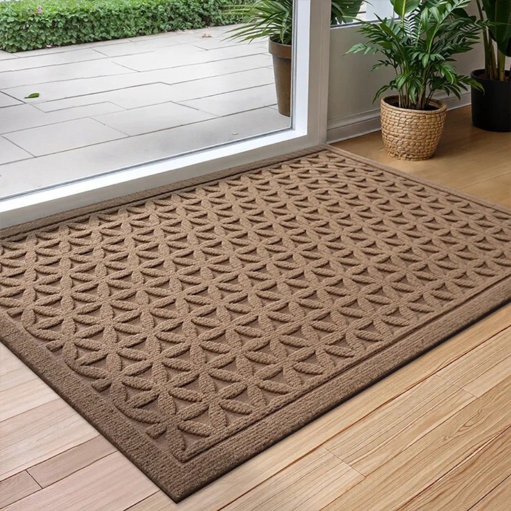 Brown grooved doormat with a raised lattice pattern at a glass door