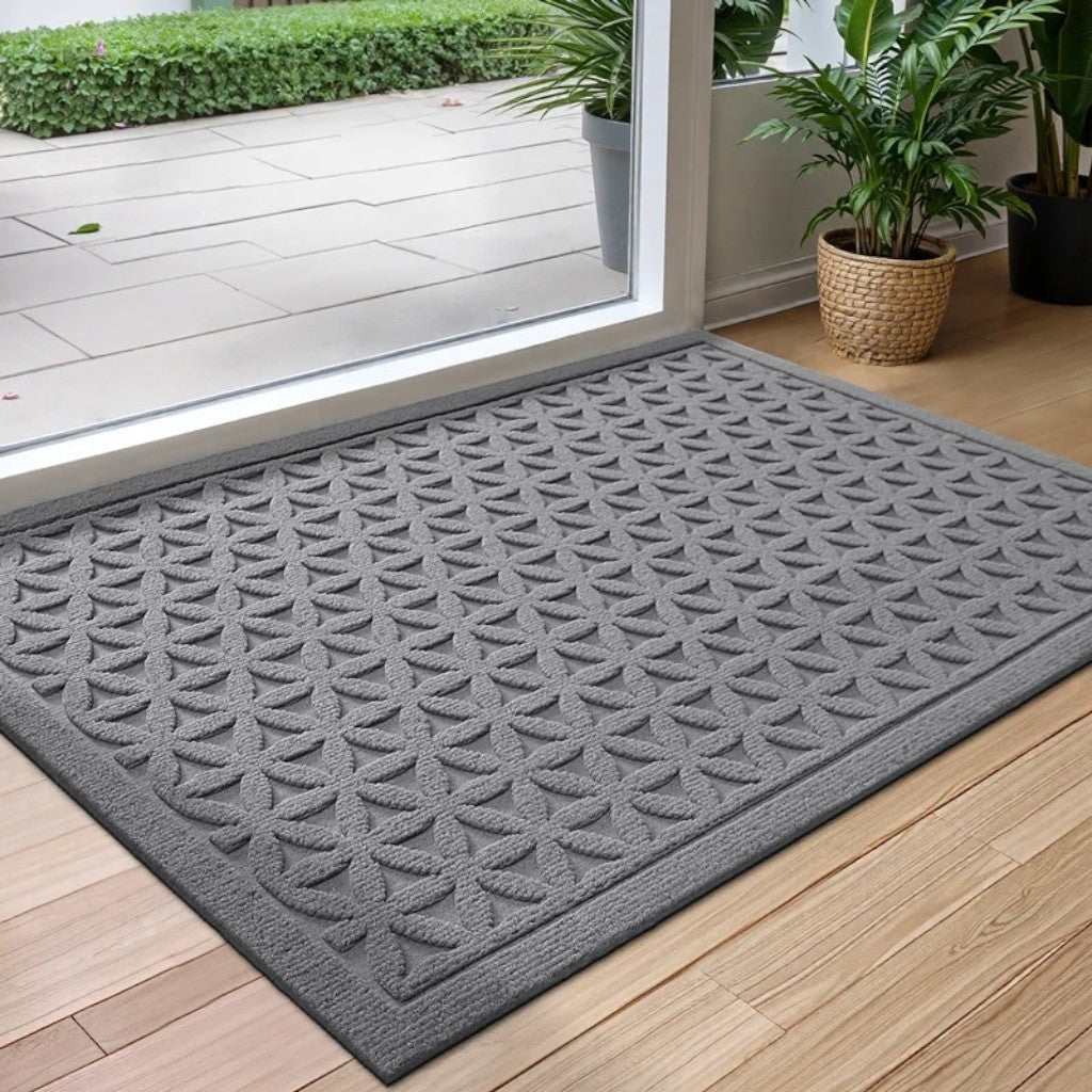 Gray grooved doormat with a raised lattice pattern at a glass door