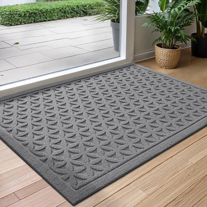 Gray grooved doormat with a raised lattice pattern at a glass door