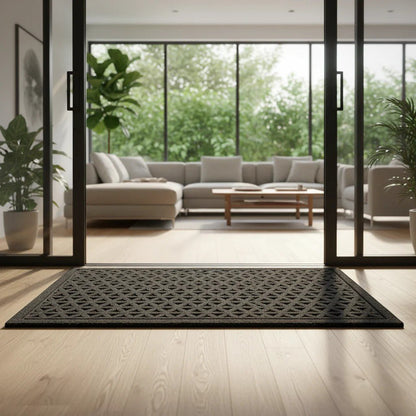 Black grooved doormat with a raised lattice pattern at a sliding glass door into a living room