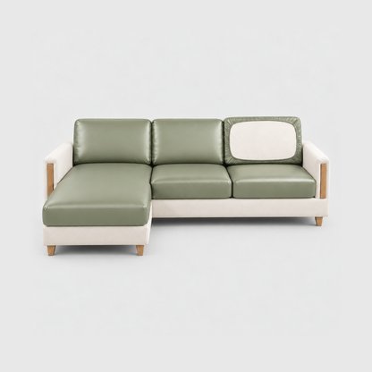 Sectional sofa with sage green PU leather cushion covers on a light gray background