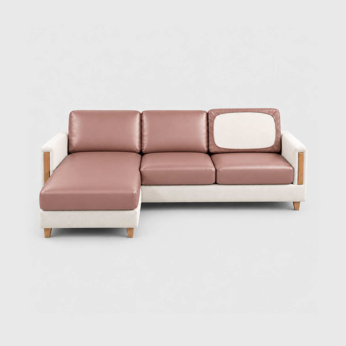 Sectional sofa with dusty pink PU leather cushion covers on a light gray background