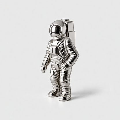 A mirror silver ceramic astronaut vase with a backpack opening, standing on a light gray background