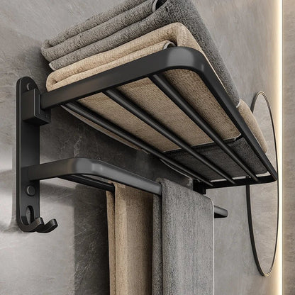Close view of a matte black towel rack holding a stack of folded towels on its shelf and two towels on the bar below