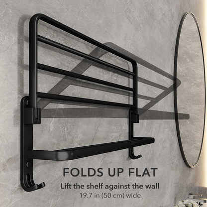 Matte black towel rack with its top shelf folded up flat against the wall, captioned folds up flat, 19.7 inches wide